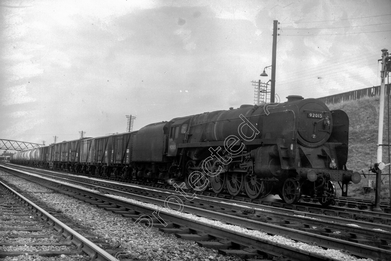 WD2611 
 ENGINE CLASS: BR Class 9 ENGINE NUMBER: 92015 LOCATION: Carnforth DATE: 14 September 1965 COMMENTS: 
 Keywords: 14 September 1965, 92015, BR Class 9, Carnforth, Cooperline, Steam, WD Cooper, locomotives, railway photography, trains