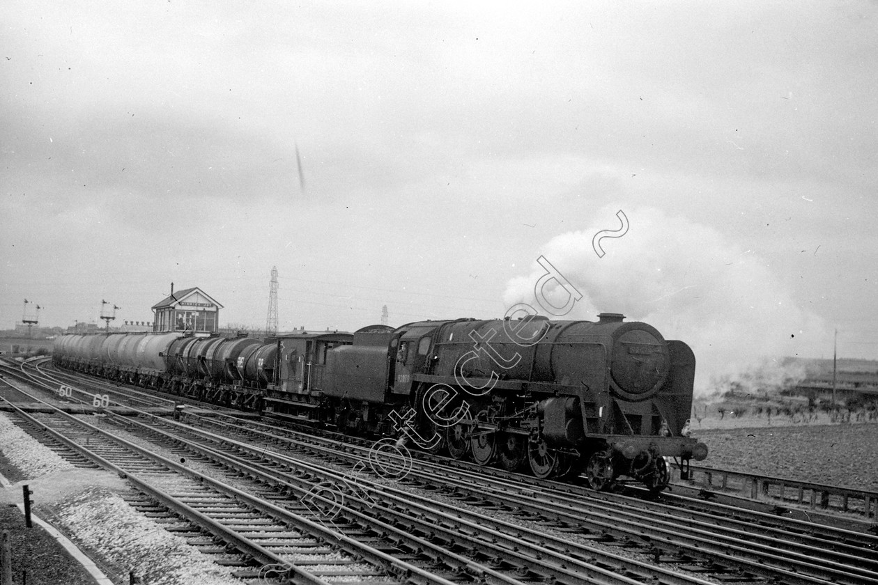 WD2643 
 ENGINE CLASS: BR Class 9 ENGINE NUMBER: 92079 LOCATION: Winwick DATE: 27 March 1965 COMMENTS: 
 Keywords: 27 March 1965, 92079, BR Class 9, Cooperline, Steam, WD Cooper, Winwick, locomotives, railway photography, trains