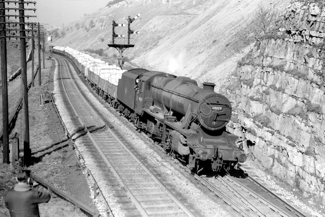 WD2035 
 ENGINE CLASS: Stanier Class 8 2-8-0 ENGINE NUMBER: 48329 LOCATION: Cheedale DATE: 23 March 1963 COMMENTS: 
 Keywords: 23 March 1963, 48329, Cheedale, Cooperline, Stanier Class 8 2-8-0, Steam, WD Cooper, locomotives, railway photography, trains