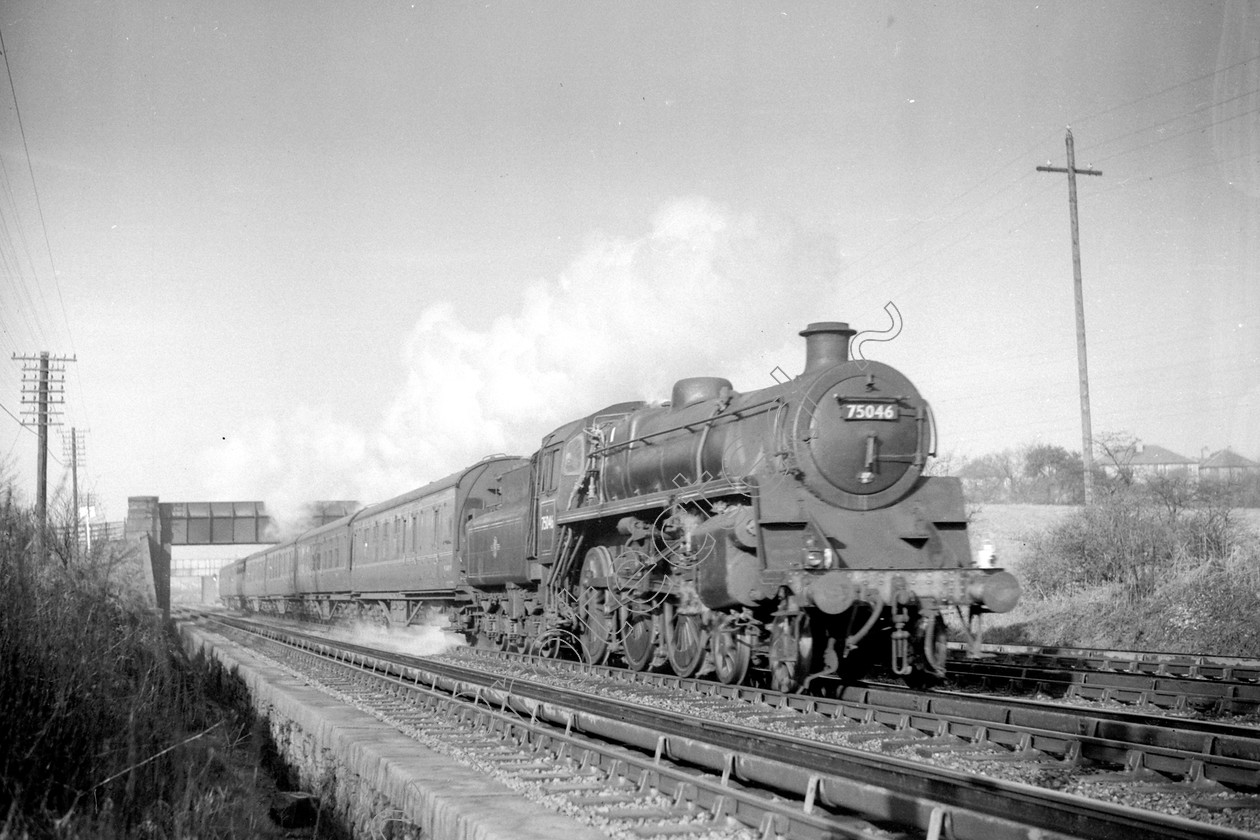 WD2491 
 ENGINE CLASS: BR 75000 4-6-0 ENGINE NUMBER: 75046 LOCATION: Walkden Troughs DATE: 15 March 1961 COMMENTS: 
 Keywords: 15 March 1961, 75046, BR 75000 4-6-0, Cooperline, Steam, WD Cooper, Walkden Troughs, locomotives, railway photography, trains