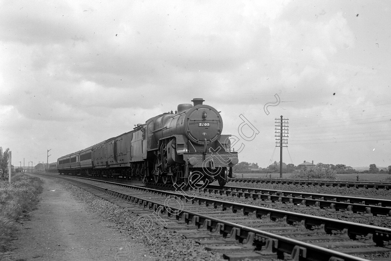 WD0601 
 ENGINE CLASS: Moguls 2-6-0 ENGINE NUMBER: 2703 LOCATION: Coppull DATE: 02 July 1938 COMMENTS: 
 Keywords: 02 July 1938, 2703, Cooperline, Coppull, Moguls 2-6-0, Steam, WD Cooper, locomotives, railway photography, trains